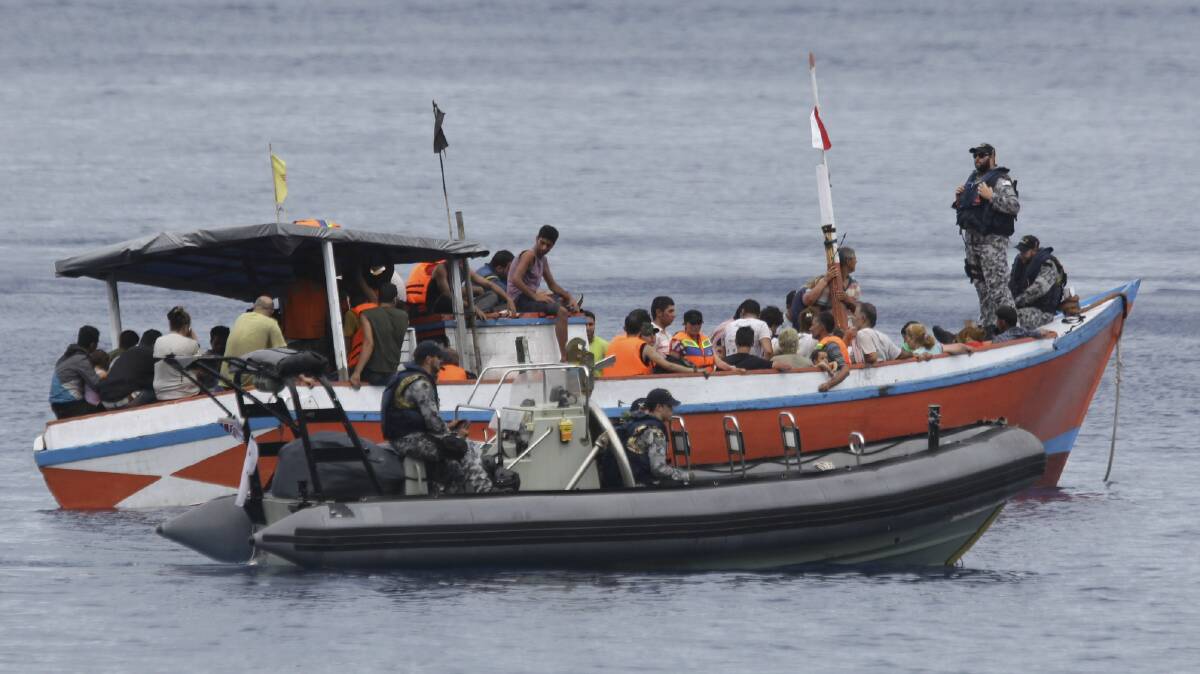 A boat full of asylum seekers arrives off Christmas Island in March. Picture: WOLTER PEETERS