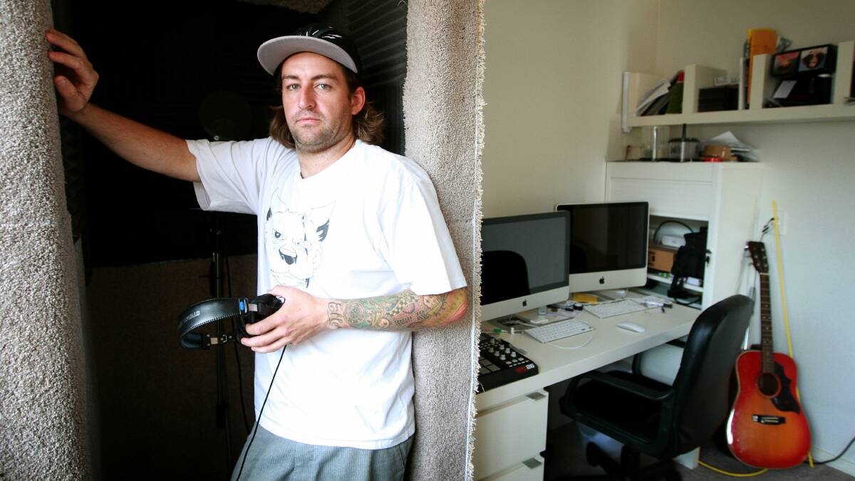 Mark Meddows, aka MC Mibbs, in his home studio in a Shell Cove suburb. Picture: SYLVIA LIBER