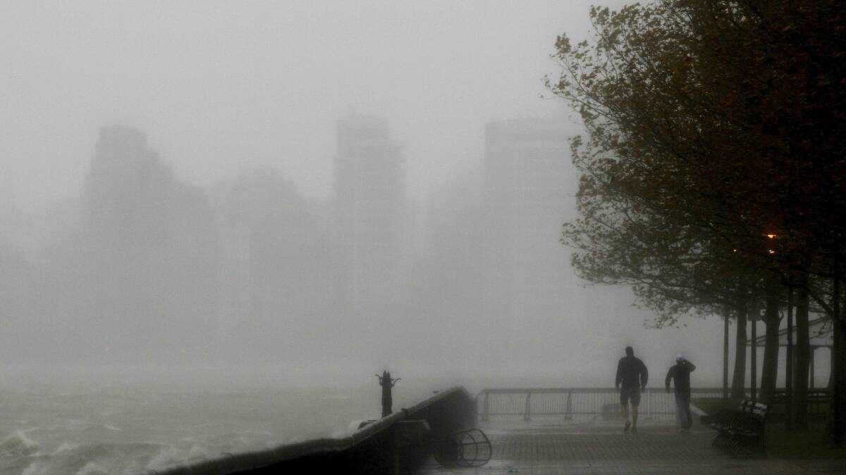 Two men walk along the Hudson River in New Jersey. Picture: REUTERS