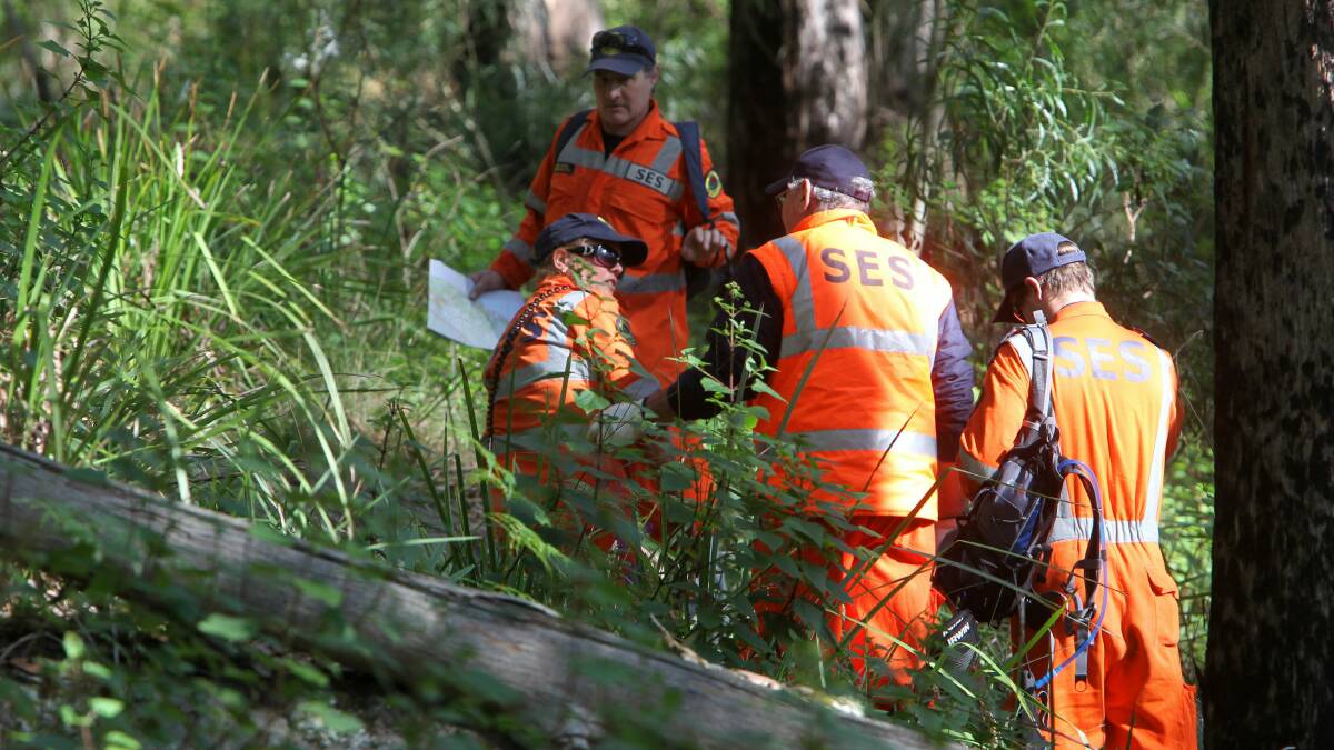 State Emergency Service workers comb bushland at Stanwell Park. 