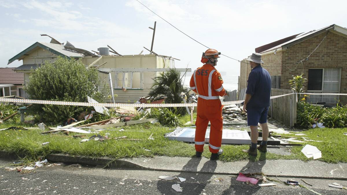 An SES worker surveys homes damaged in Sunday's storm. Picture: SYLVIA LIBER