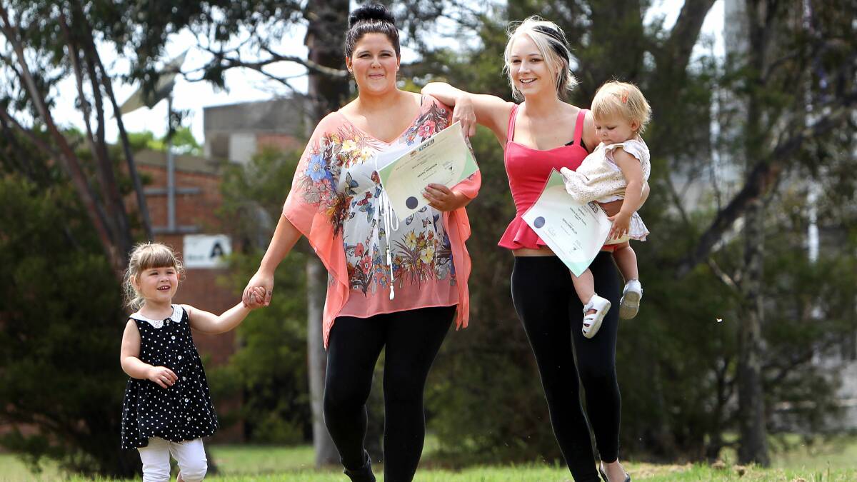 Kristel Thompson, with her daughter Lilly, and Sarah Miller, with her daughter Elisa, are among the first to graduate from TAFE Illawarra's Certificate II. Picture: SYLVIA LIBER