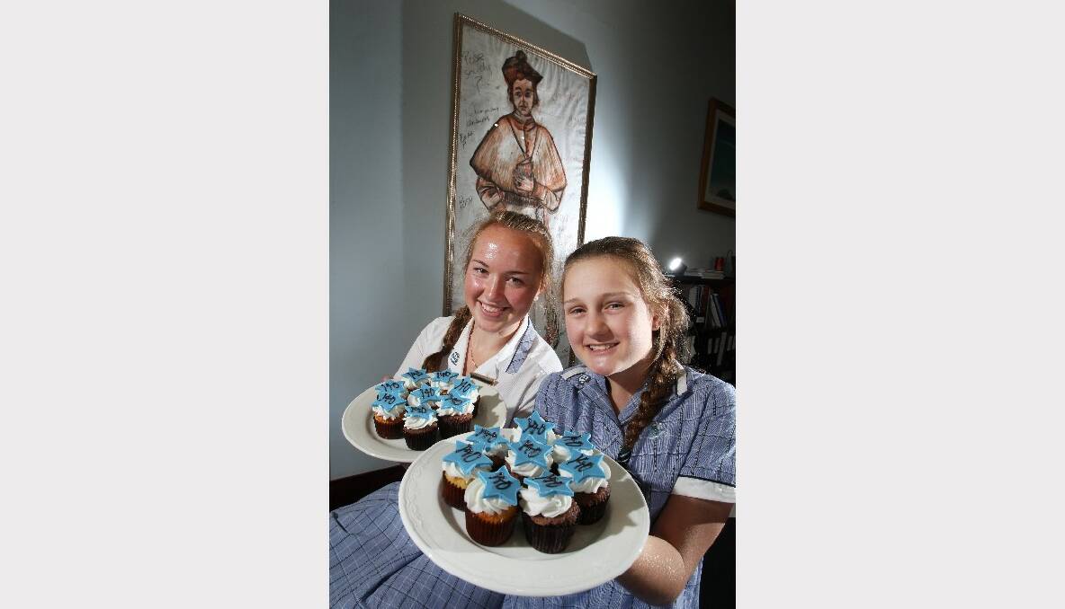 Yearr 12 student Lucy Packer and year 8 student Eleanor Mantei celebrate the school's 140th anniversary. Picture: KEN ROBERTSON