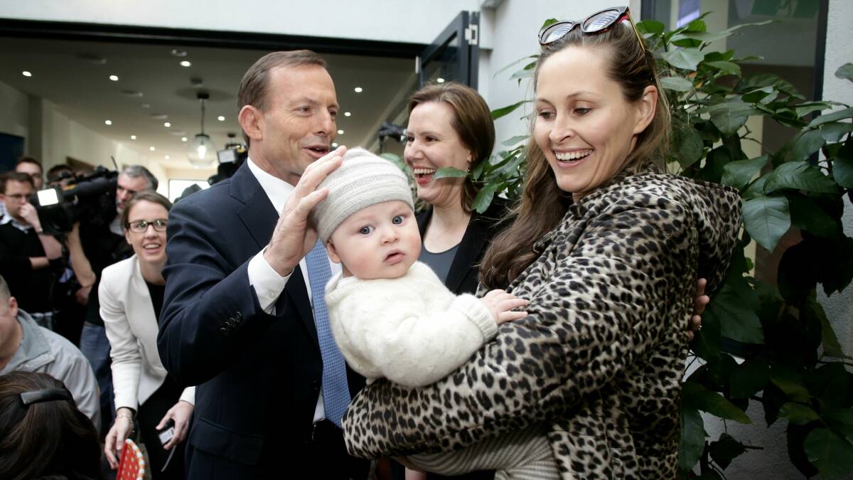 Opposition Leader Tony Abbott meets Amelia Taylor and 5-month-old Thomas on the campaign trail yesterday. Picture: Alex Ellinghausen