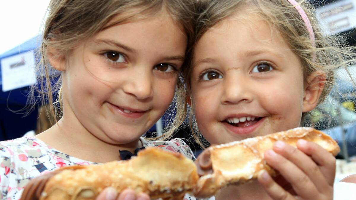  Sisters Charley and Ruby Fowler sample some cannoli. Pictures: GREG TOTMAN