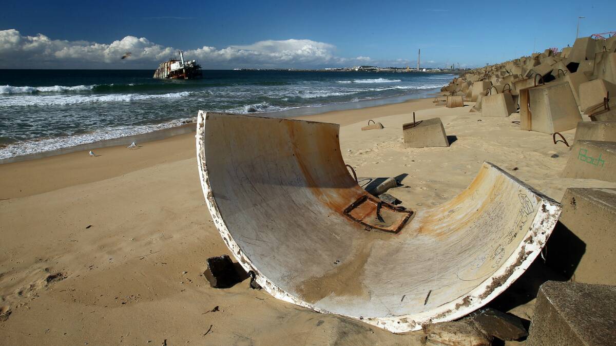 Part of the cowling from the disused wave generator off the coast at Port Kembla lies on the beach. Pictures: KIRK GILMOUR