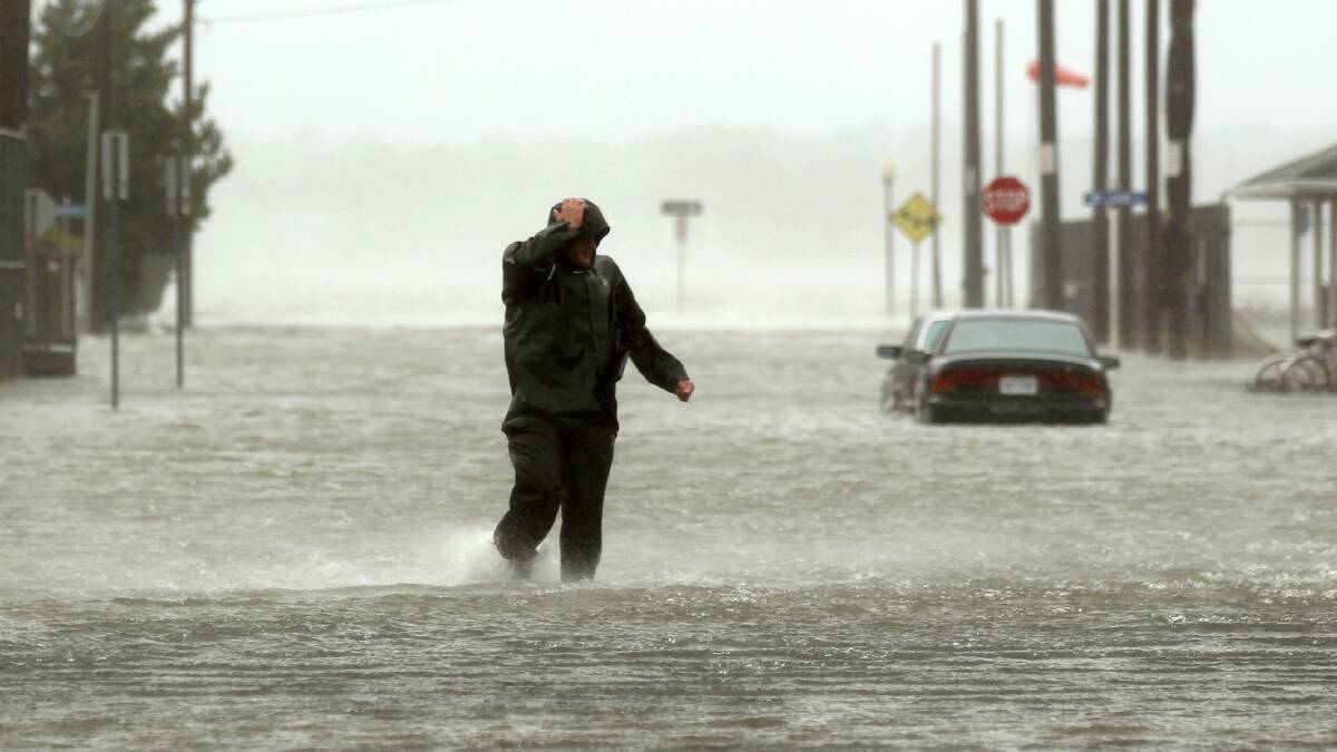 A man wades through a flooded street in Maryland. Picture: REUTERS