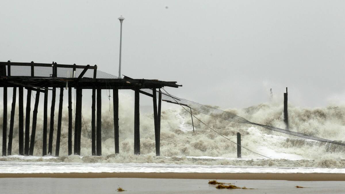 Waves crash into a collapsed pier in Maryland. Picture: REUTERS