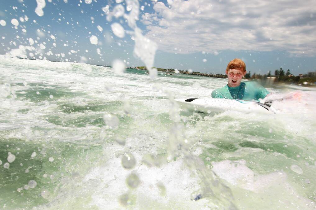 Hawks player Luke Jamieson hits the surf at Wollongong's North Beach. Picture: SYLVIA LIBER