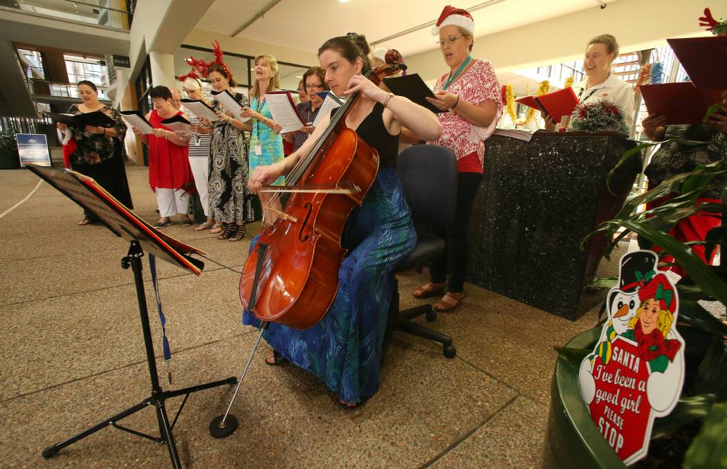 NSW government office staff sing Christmas carols in the foyer of their Wollongong office block. Picture: KIRK GILMOUR