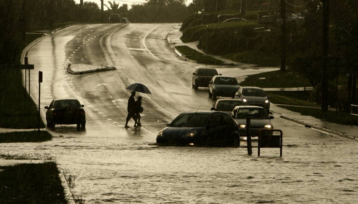 Cars and pedestrians try to negotiate a flooded Northcliffe Drive in Berkeley in February. Picture: ANDY ZAKELI