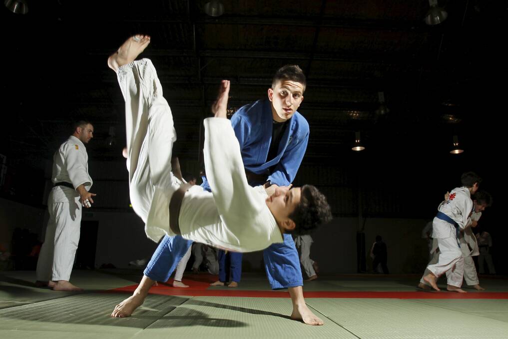 Illawarra judo club members and brothers Kosta Kouros (blue) and Anthony Kouros in action. Picture: DAVE TEASE