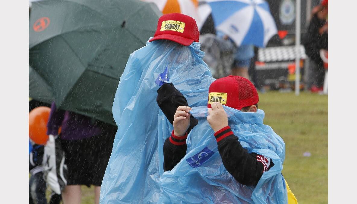 Kids in their rain ponchos at the 2013 i98FM Camp Quality Convoy for Kids. Picture: ANDY ZAKELI