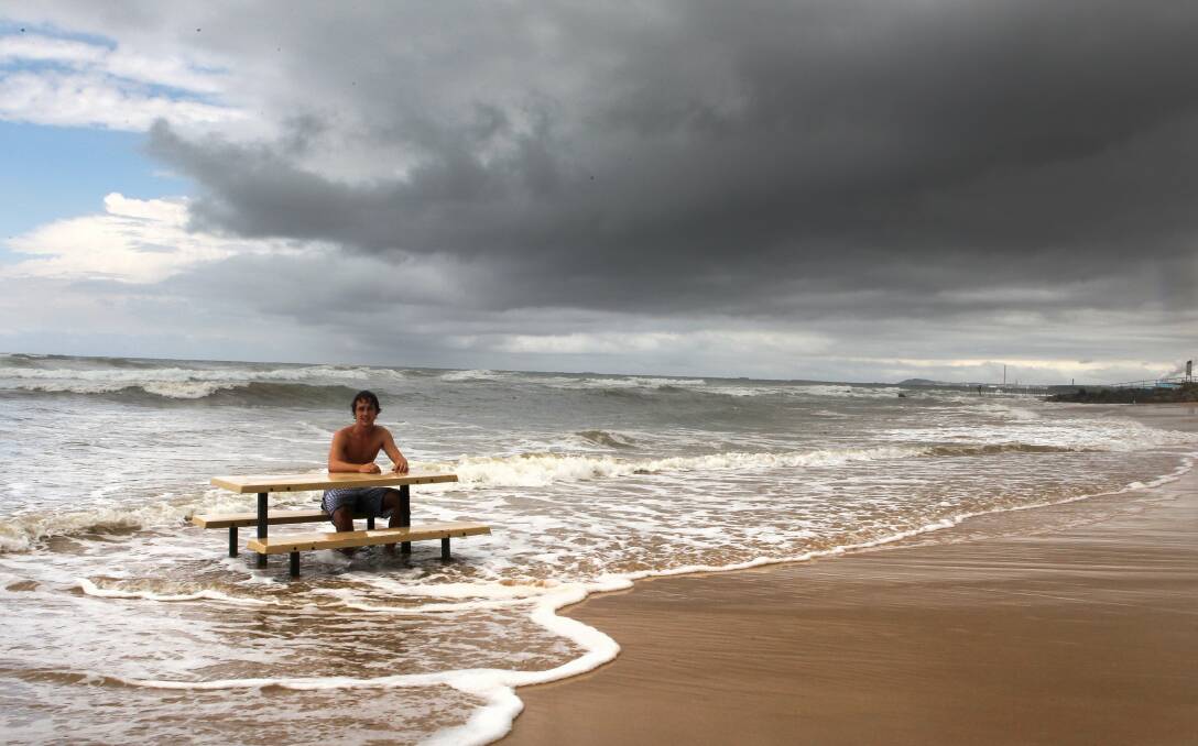 Cameron Geraghty sits on a park bench in the surf at Corrimal Beach after February floods. Picture: KIRK GILMOUR