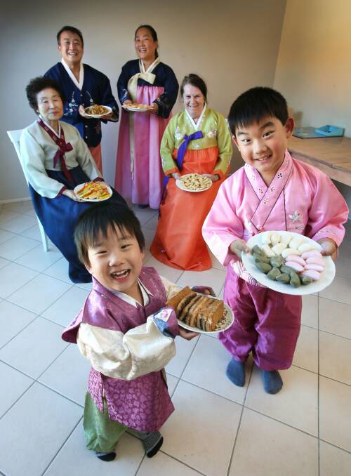 (Clockwise from left) Flint Kim, 3, Chanam Choi, Wonsock Kim, Mihyun Lim, Norma Blinkhorn and Aric Kim, 8, get ready for the lunar new year. Picture: KIRK GILMOUR