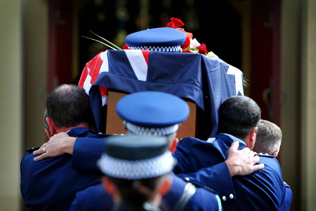 Friends and family pay their last respects to Chief Inspector Graeme Donnelly on August 26. Picture: SYLVIA LIBER