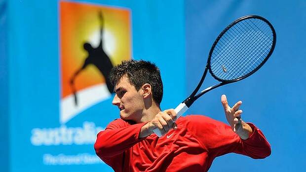 Bernard Tomic goes through his paces at Melbourne Park before his first-round match. Picture: Justin McManus