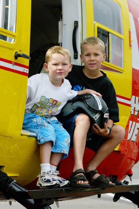 Kyle (left) and Bradley on board the Westpac Life Saver Rescue Helicopter at the Fraternity Club.