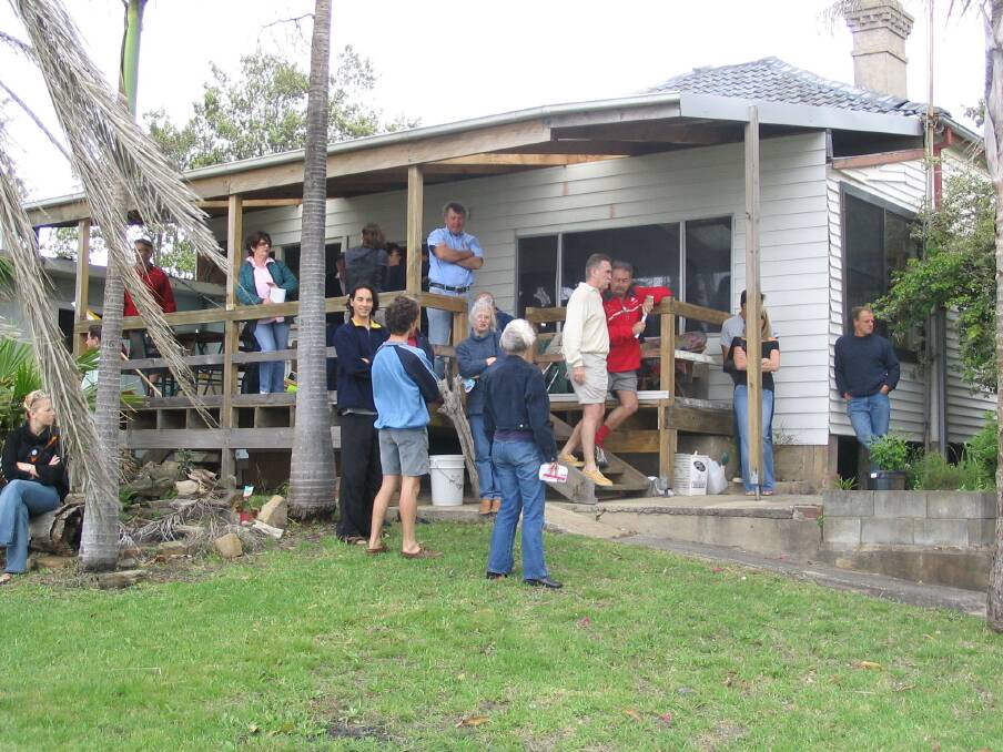 Onlookers and bidders have a look around this 1930s timber cottage at Reef Avenue, Wombarra, which sold for $2.25m.