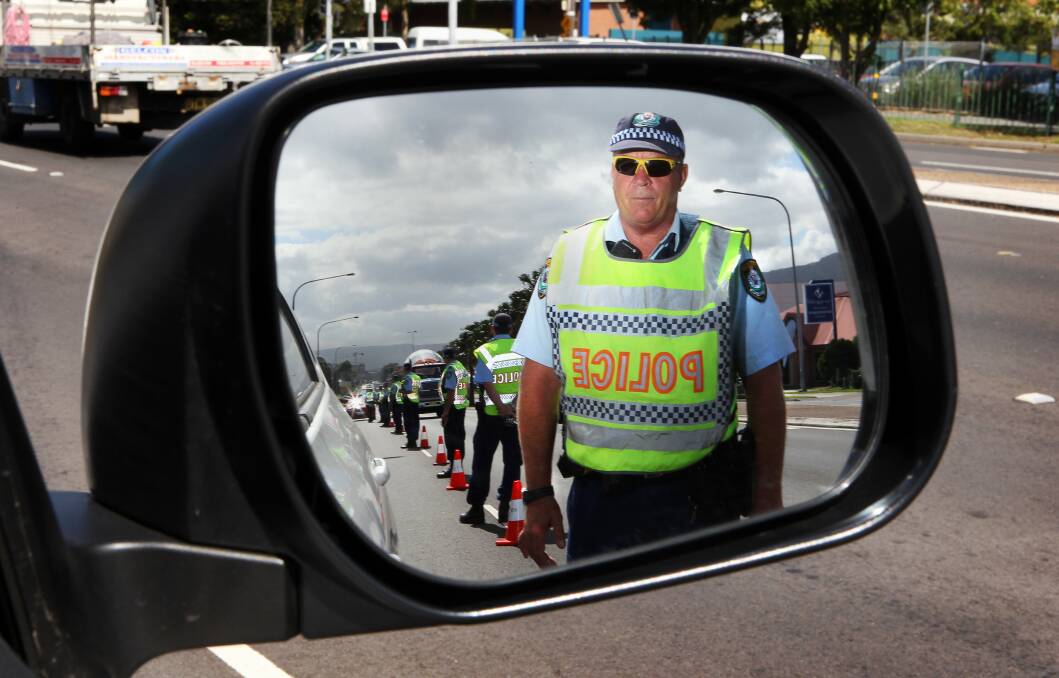 Leading Senior Constable Kym Hutton conducts random breath-testing at North Wollongong in April. Picture: KIRK GILMOUR