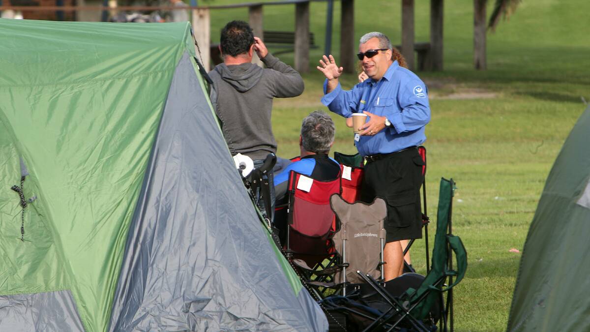 A Wollongong City Council ranger talks to campers at Stuart Park on New Year's Day. Picture: KIRK GILMOUR