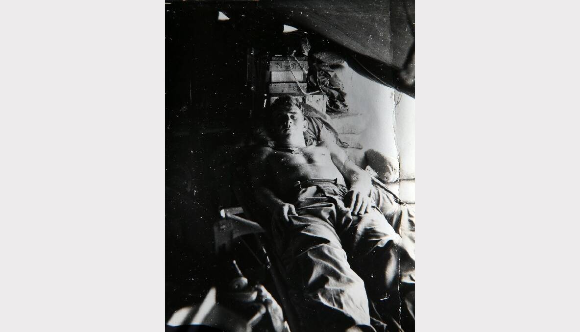 Lying in his tent while serving in Vietnam.