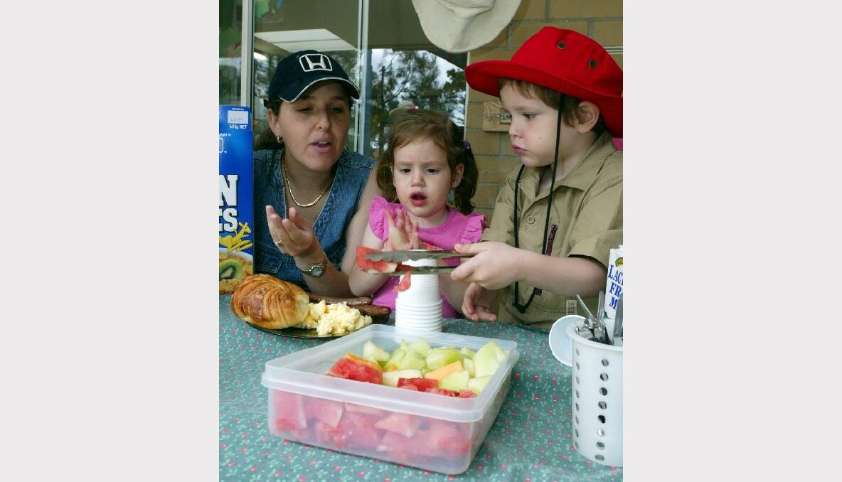 Wollongong mum Christina Brown and her children Callum, 4, and Lola, 2, tuck into family breakfast at the South Coast workers Child Care Centre.