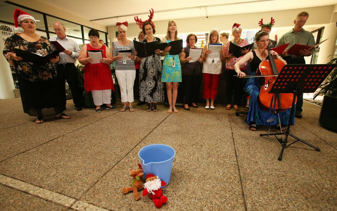 NSW government office staff sing Christmas carols in the foyer of their Wollongong office block. Picture: KIRK GILMOUR