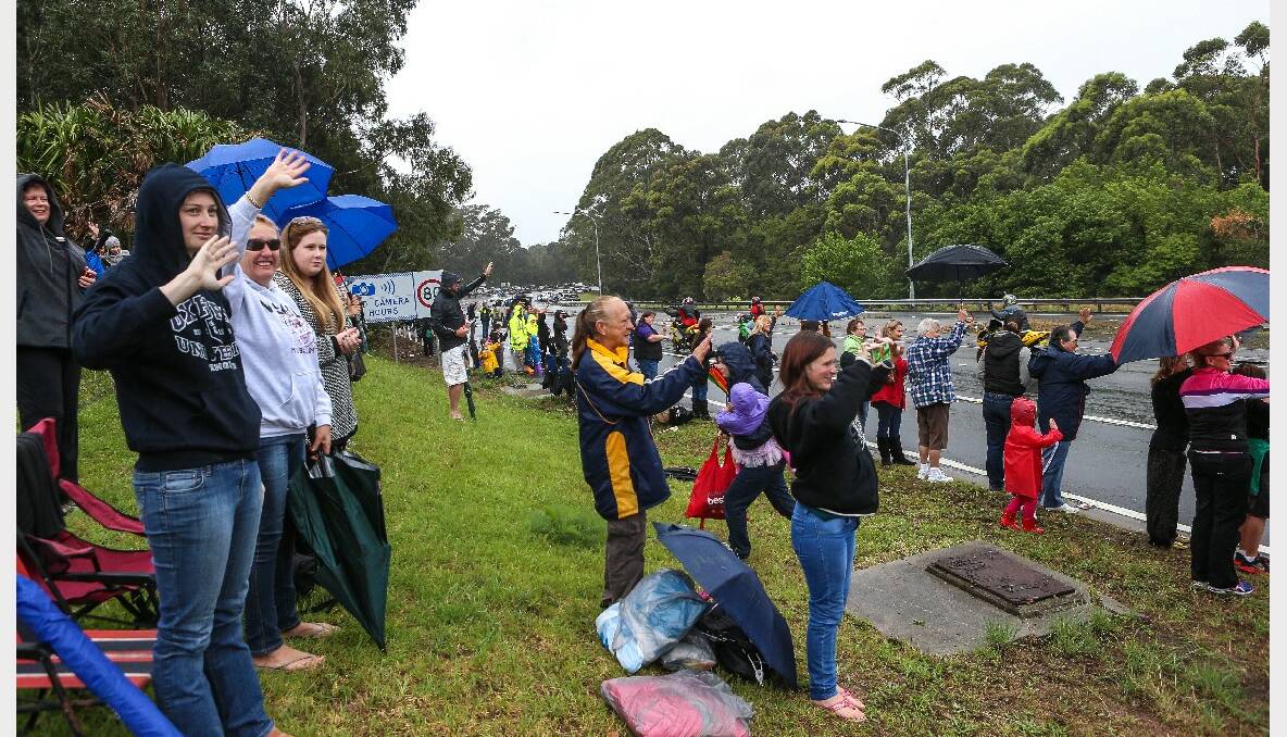 Crowds gather along Mt Ousley Road to watch the 2013 i98FM Camp Quality Convoy for Kids. Picture: ADAM McLEAN