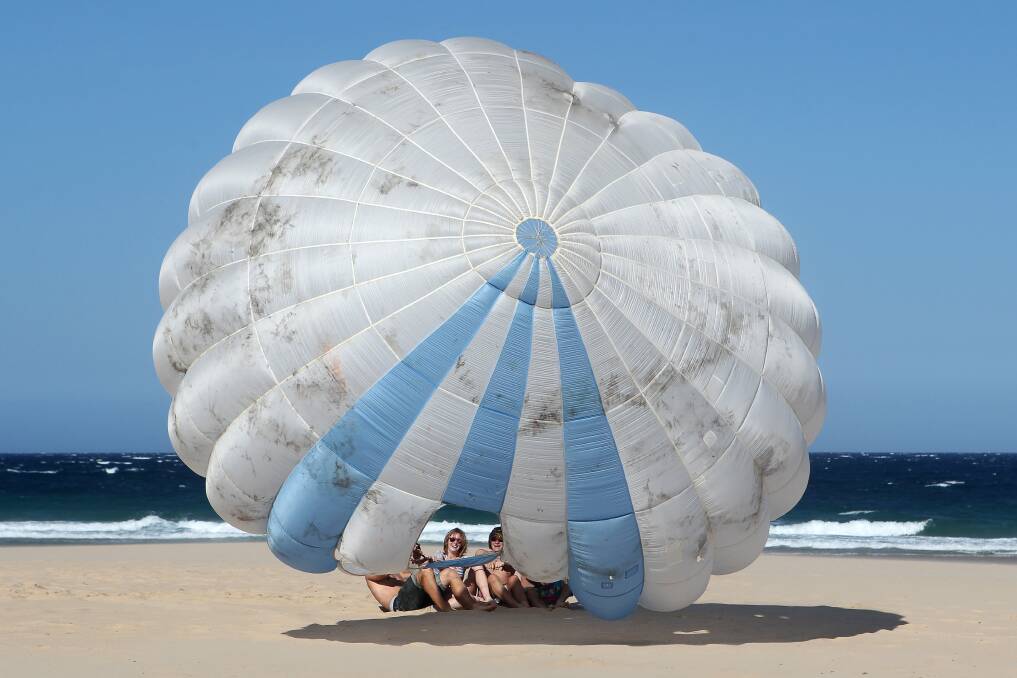 Parachute play at Wollongong's North Beach. Picture: SYLVIA LIBER