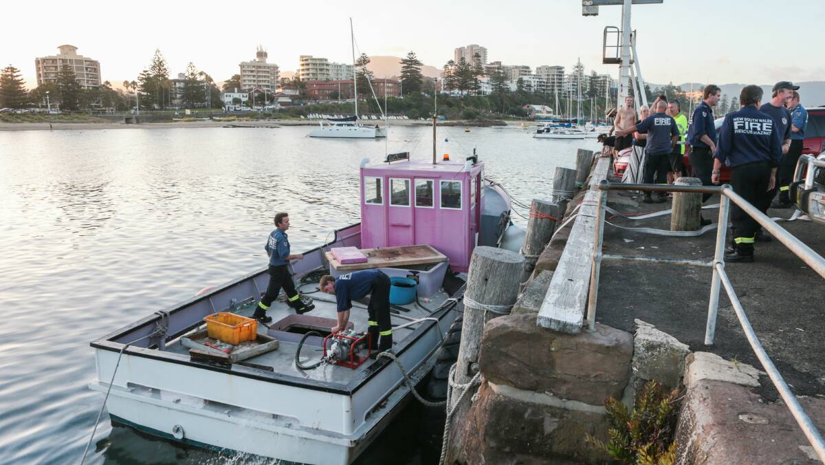Emergency services work to stabilise the sinking boat in Wollongong Harbour. Pictures: ADAM McLEAN