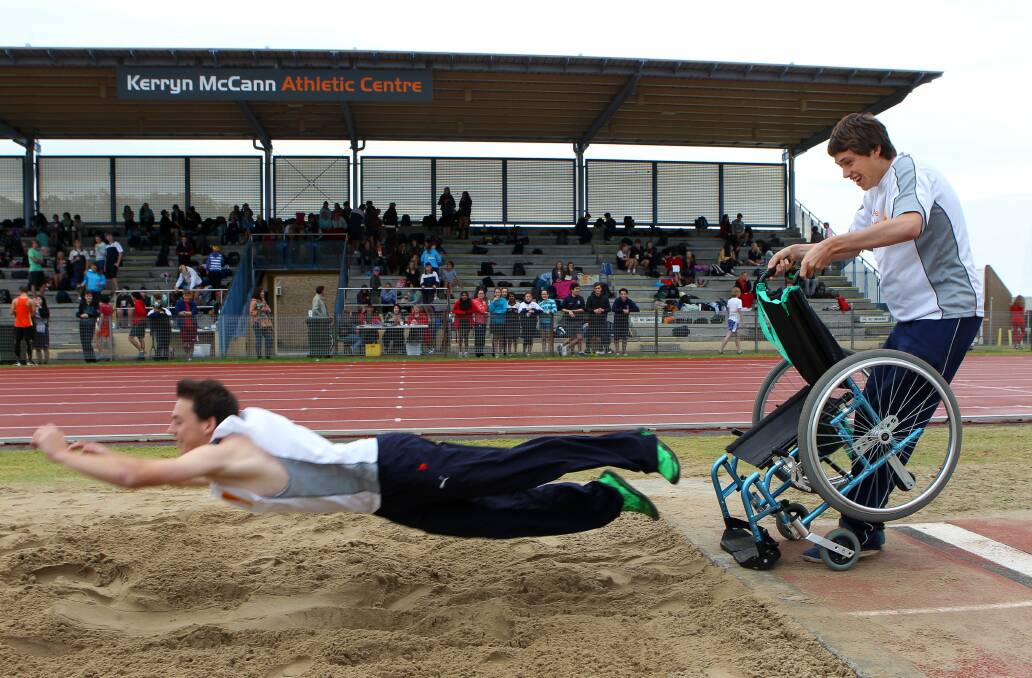 Nick Hennessy and Elliot Gooding perform wheelchair long-jump in May to raise money for House With No Steps. Picture: KIRK GILMOUR