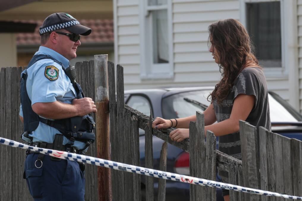 Police speak with neighbours at the scene of the shooting. Picture: ADAM McLEAN