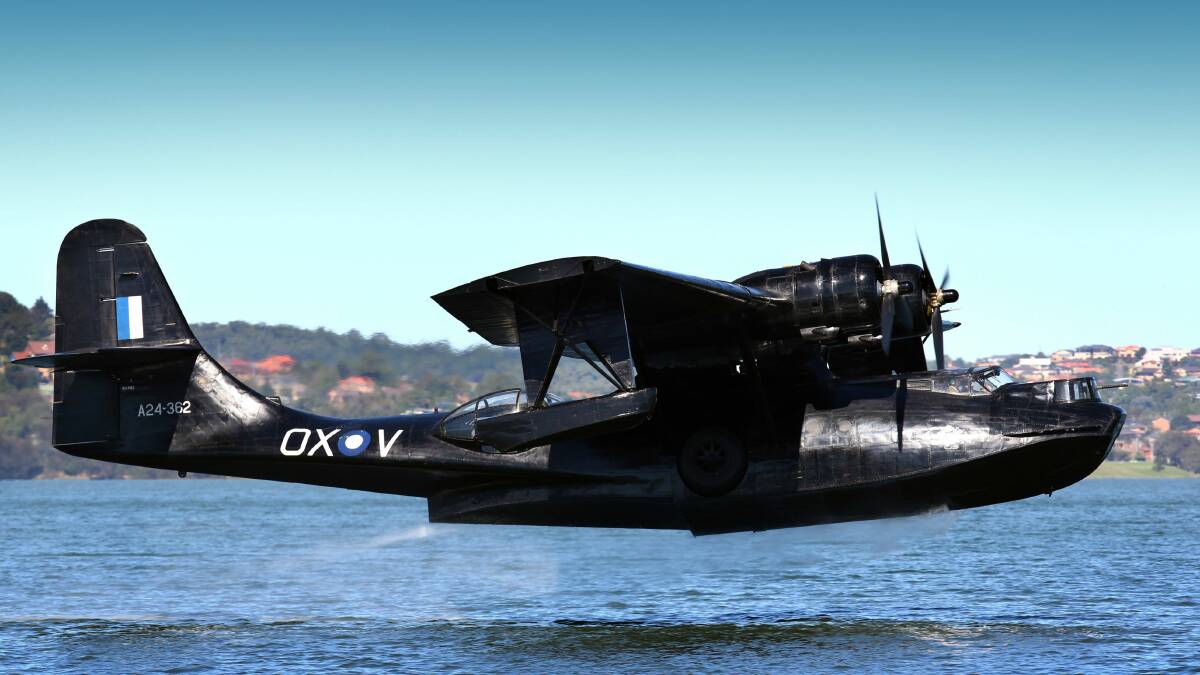 A 1945 Catalina flying boat touches down in Koonawarra Bay on Lake Illawarra. Pictures: KEN ROBERTSON