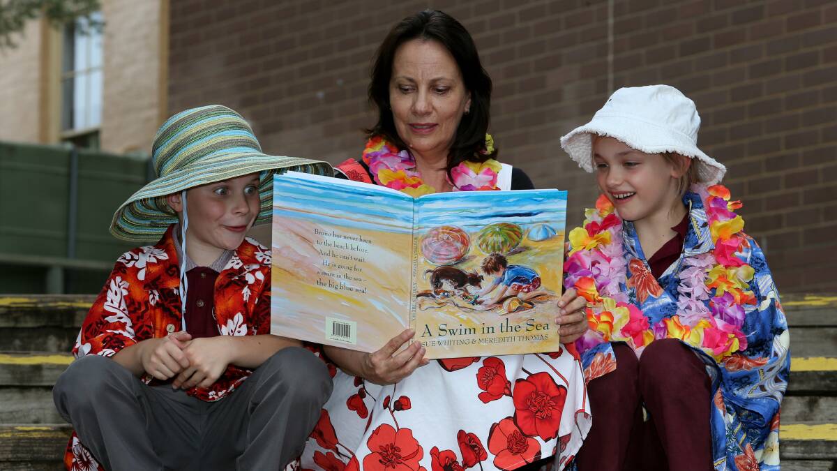 Author Sue Whiting reads to seven-year-olds Jed Parker and Evie Bosker. Picture: ROBERT PEET