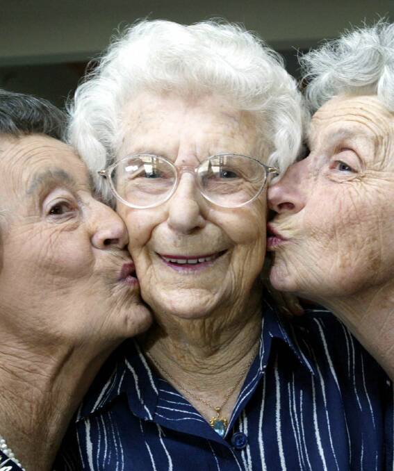 Esme Morton, left, and Lila Badior, right, congratulate their cousin Alma Parsons, who said turning 101 felt ‘‘extraordinary’’.