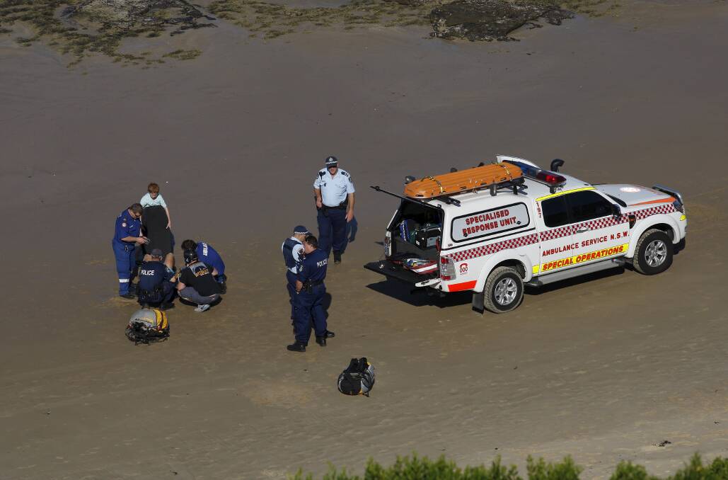 Paramedics treat the patient at Fishermans Beach. 