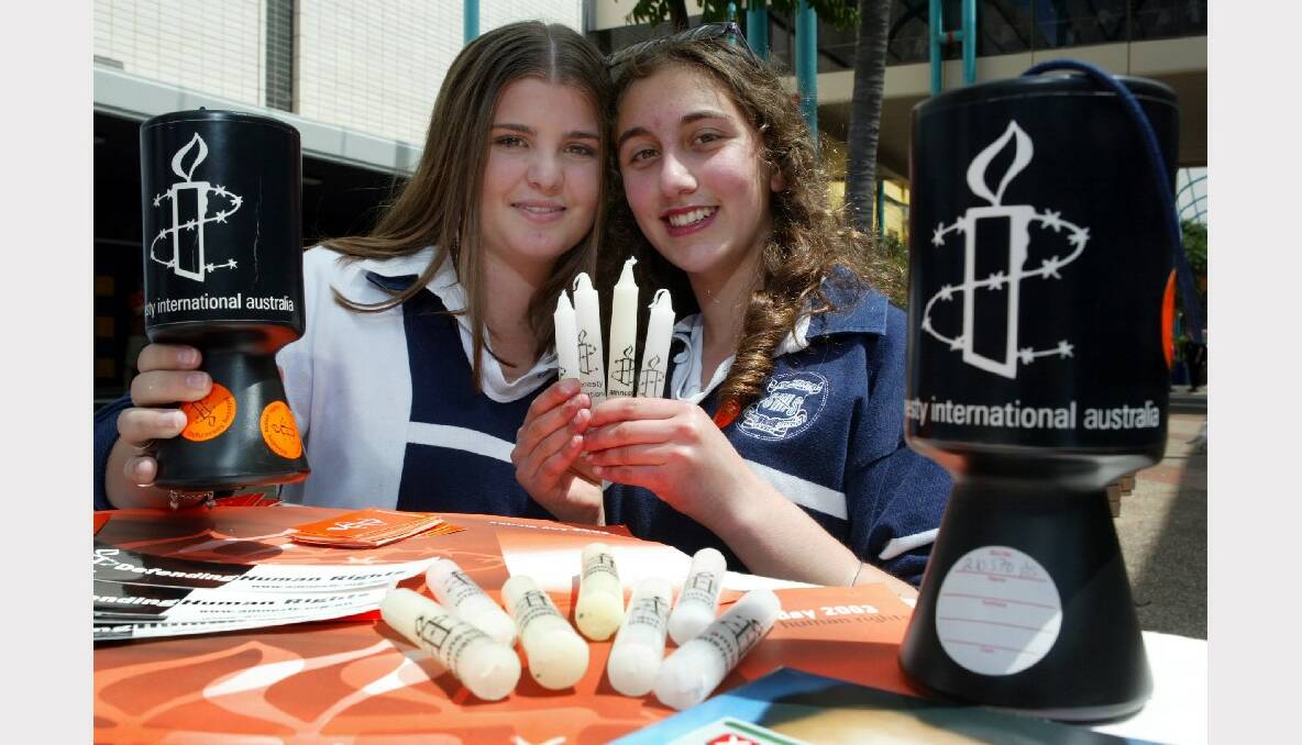 Smiths Hill High School students Becky,15, and Negin,15, sell candles in Crown St Mall for Amnesty International.