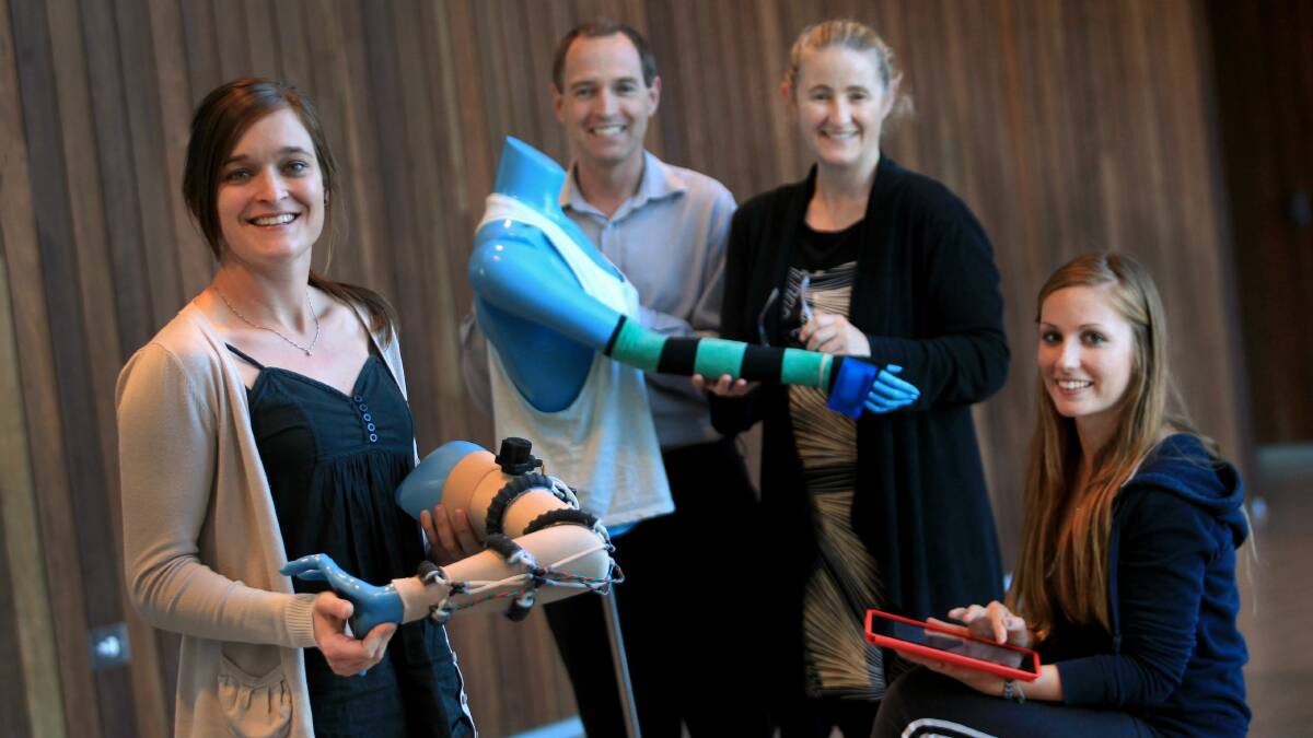 UOW student Julia Fellow with Professor Geoff Spinks, Dr Bridget Munro and student Rosie Sadler with a prototype of the lymphoedema sleeve. Picture: ORLANDO CHIODO