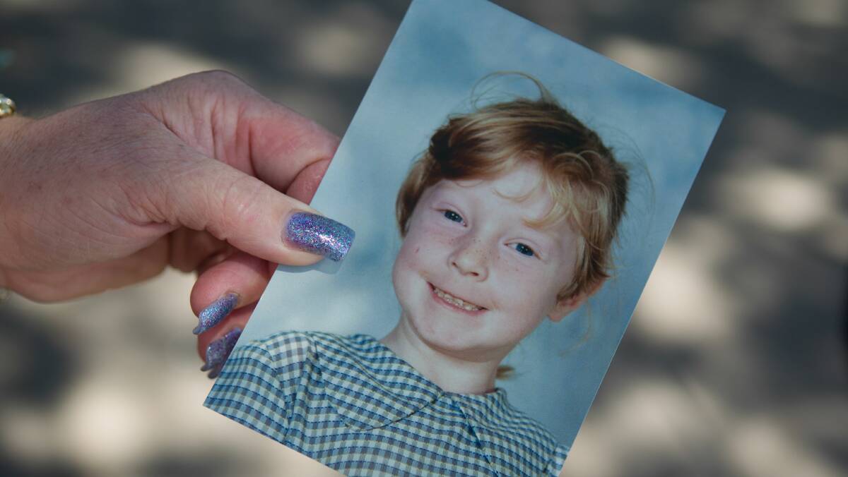 Kathy McDonald with a photo of her daughter as a child. Pictures: CHRISTOPHER CHAN  
