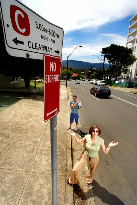 Corrimal Street residents Peter Menzies and Renee Lintescu ponder which sign to obey.