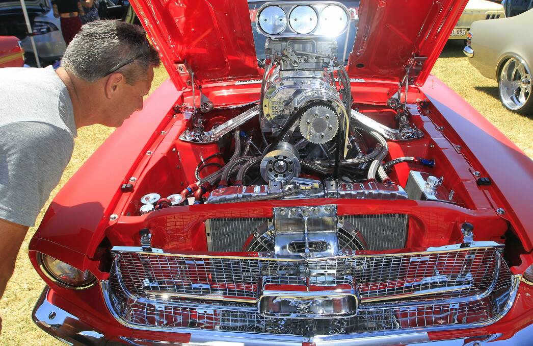 Berkeley local John Miners checks out a 1968 Ford Mustang with souped-up engine at the Autorama Car and Bike Expo. Picture: ANDY ZAKELI