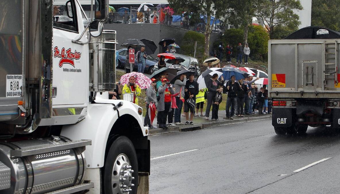 Crowds gather along Lake Entrance Road to watch the 2013 i98FM Camp Quality Convoy for Kids. Picture: ANDY ZAKELI