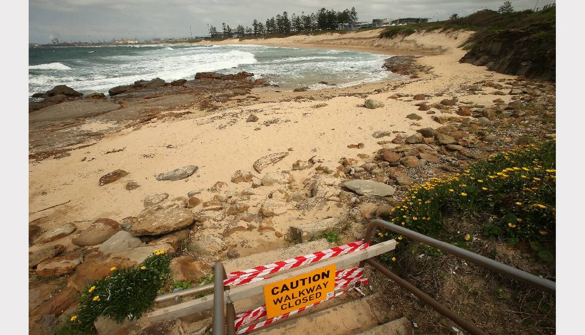 Large swells have washed away dunes forcing Wollongong City Council to close beach walkways. Picture: KIRK GILMOUR 