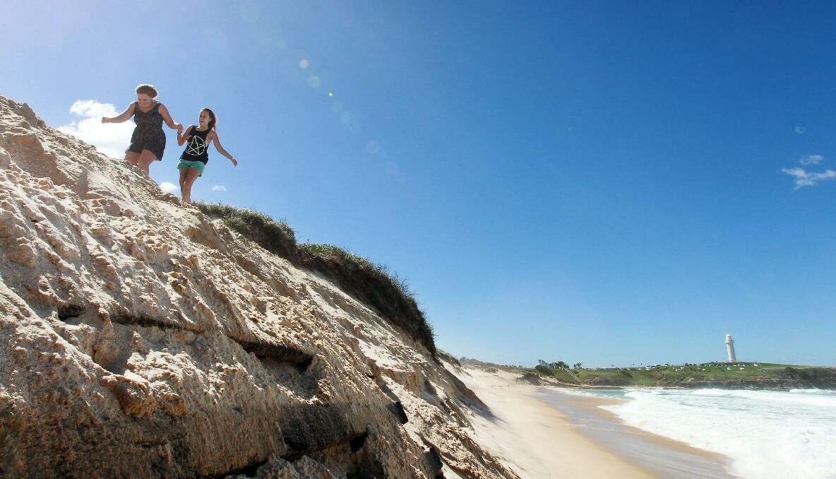 Ashleigh Smith, left, and Michaela Norris on an eroded sand dune at City Beach. Picture: SYLVIA LIBER