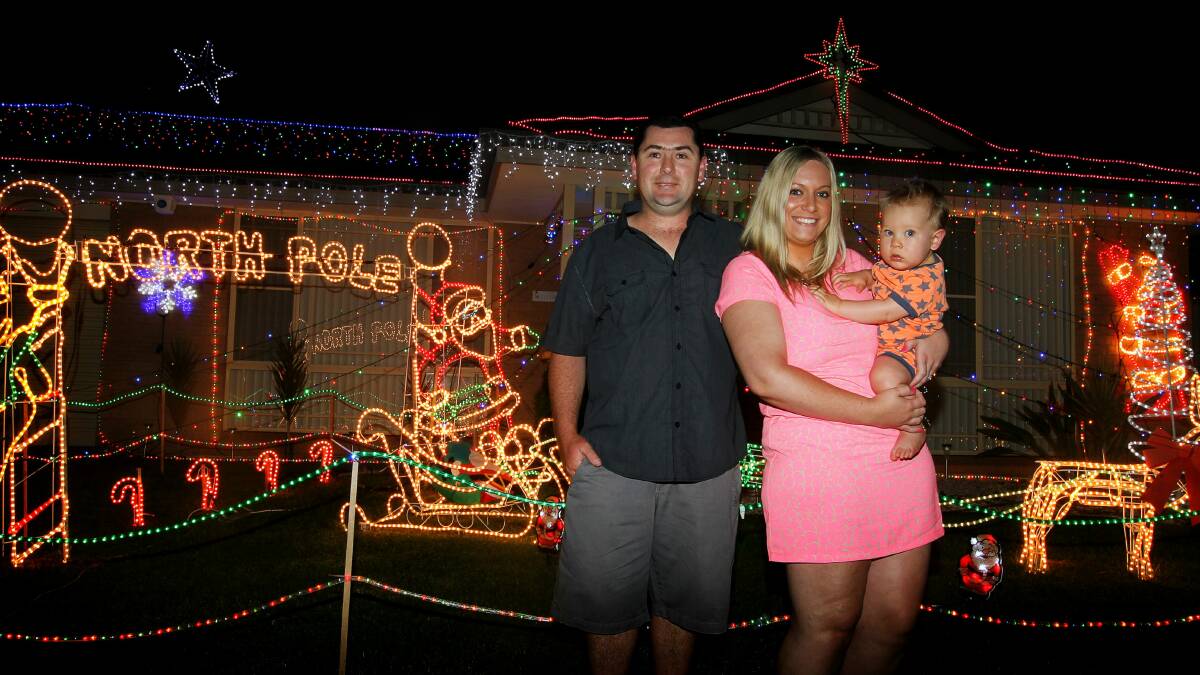 Nathian, Elleni and Lachlan Mackay outside their Christmas-decorated home in Stubbs Road, Albion Park. Picture: SYLVIA LIBER