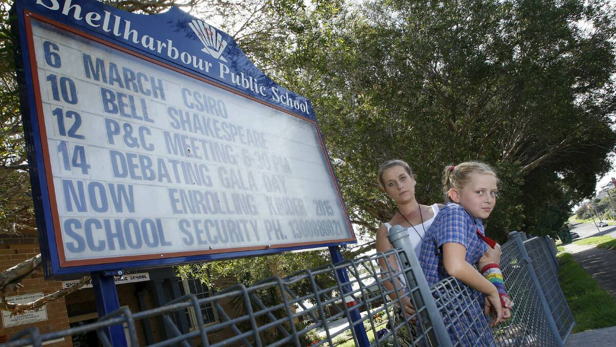 Jess Crouch, with daughter Rylee, 9, wants a security fence around Shellharbour Public School to prevent vandalism. Picture: ANDY ZAKELI