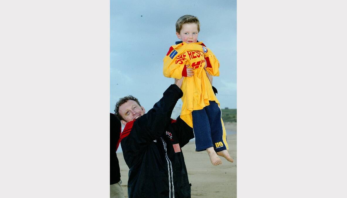 Callum, 3, gets a boost from Canada's 2003 Rugby World Cup full-back and former Australian Quentin Fyffe at Woonona Beach.
