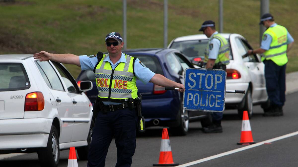 Lake Illawarra highway patrol officers conduct random breath tests as part of Operation Safe Arrival. Picture: GREG TOTMAN