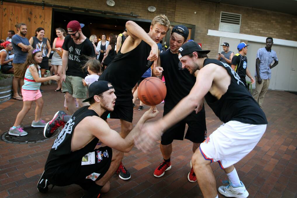 Cafe workers compete with each other during the Globe Lane cafe basketball tournament. Picture: SYLVIA LIBER